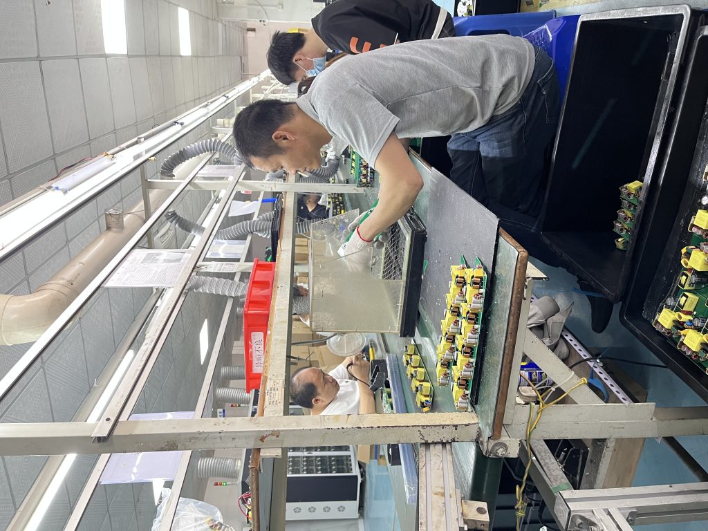 FANGXIN battery charger inspection board for solder joints and component placement.